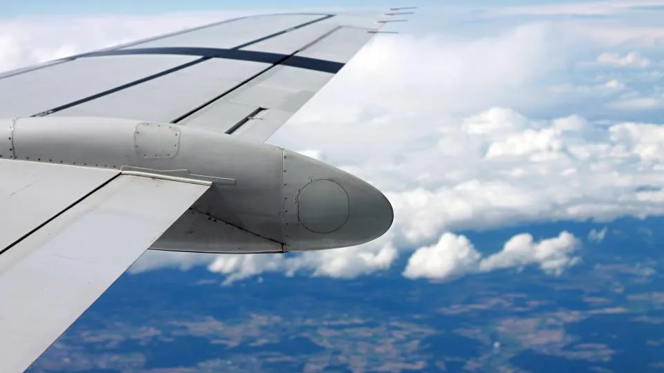 View of an aircraft wing above the clouds