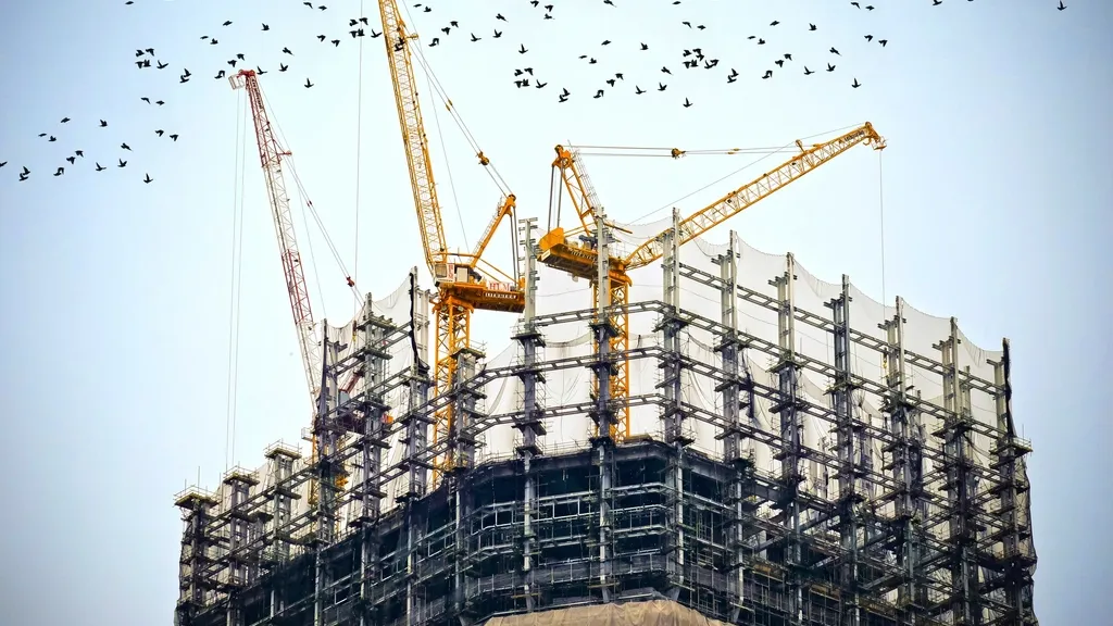 Tower cranes above a building under construction