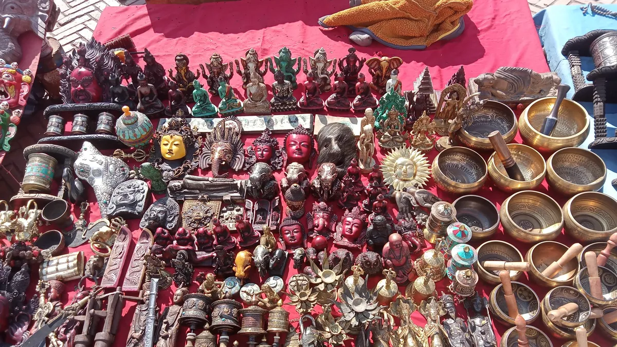 Market stall with singing bowls, statues, masks, and other traditional handicrafts