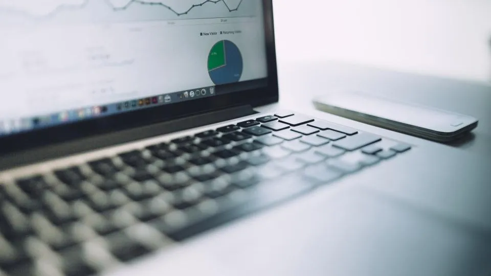 Laptop showing analytics charts on a desk