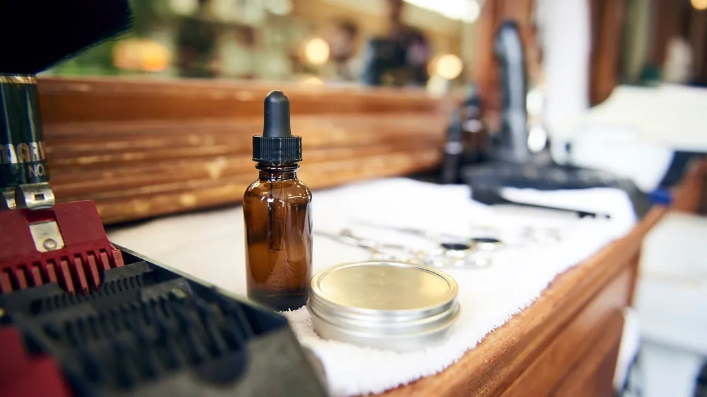 Grooming oil bottle and tin on a salon counter