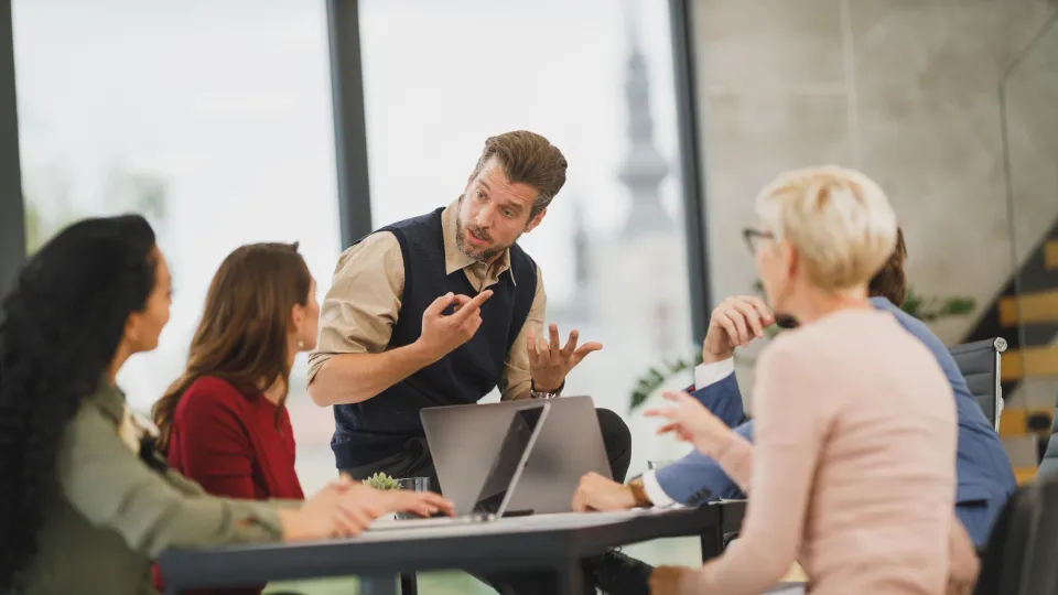 Group of people in a discussion around a table