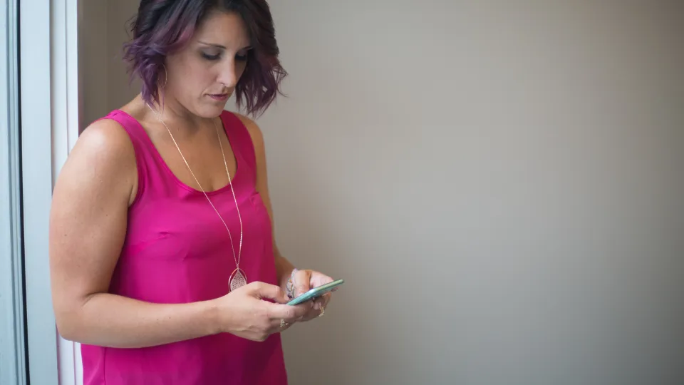 Woman replying to customer messages on her phone