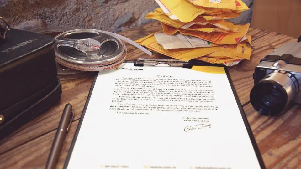 A printed document on a clipboard on a wooden desk