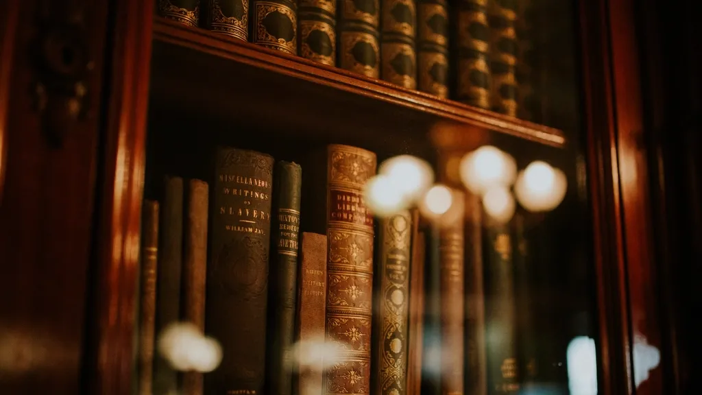 Old leather-bound books on a wooden bookshelf