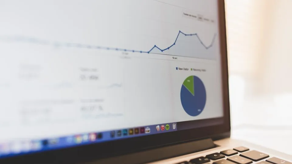 Laptop showing a web analytics dashboard with conversion charts