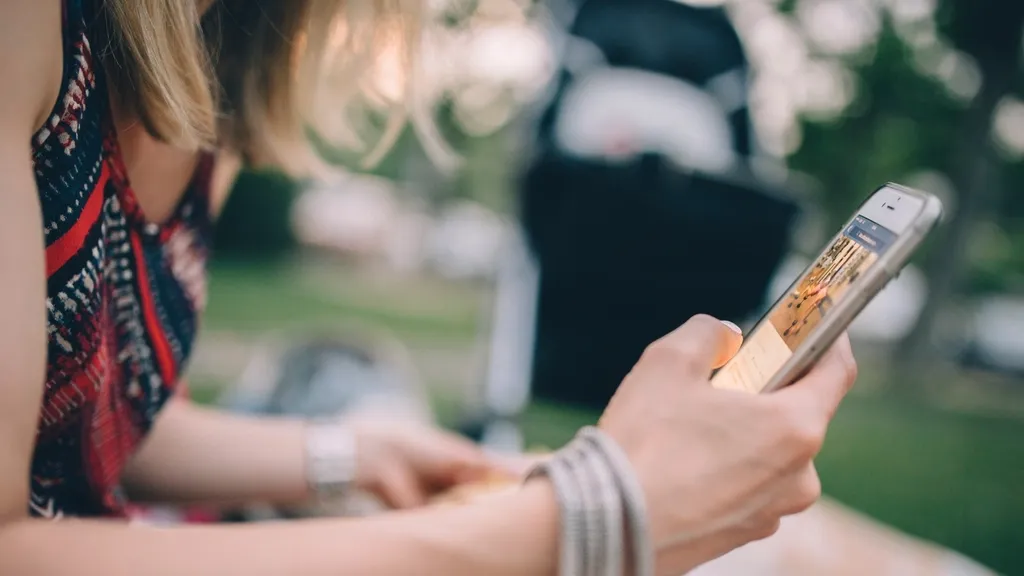 Woman sharing something on her smartphone outdoors