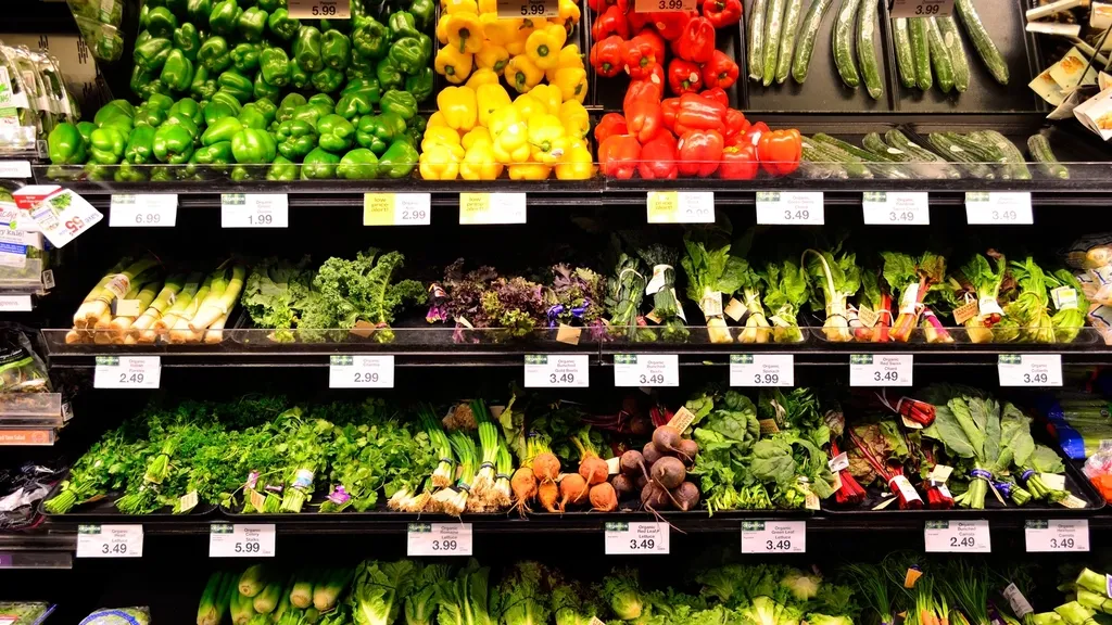 Shelves of fresh vegetables with price labels in a store