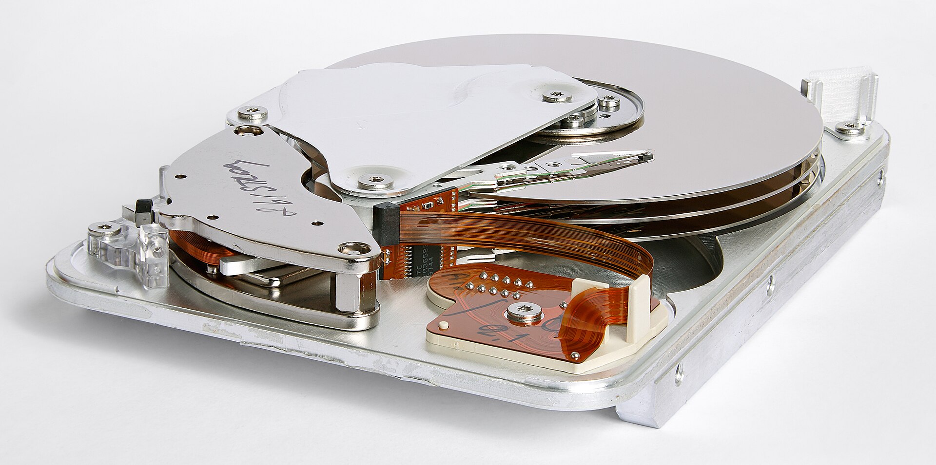 Opened 3.5-inch hard drive showing the platter and read/write arm