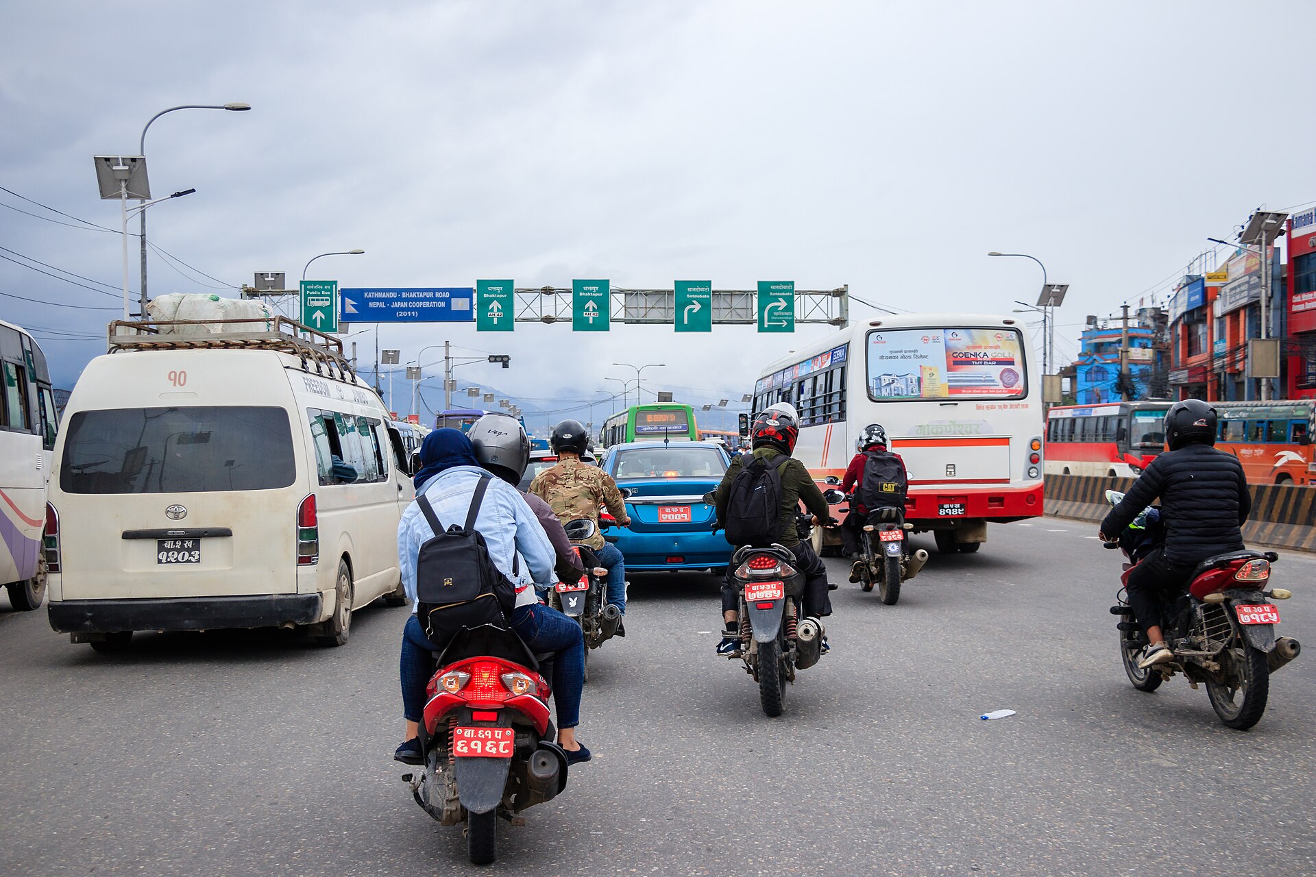 Motorbikes, a microbus and buses packed onto the road at Koteshwor, Kathmandu