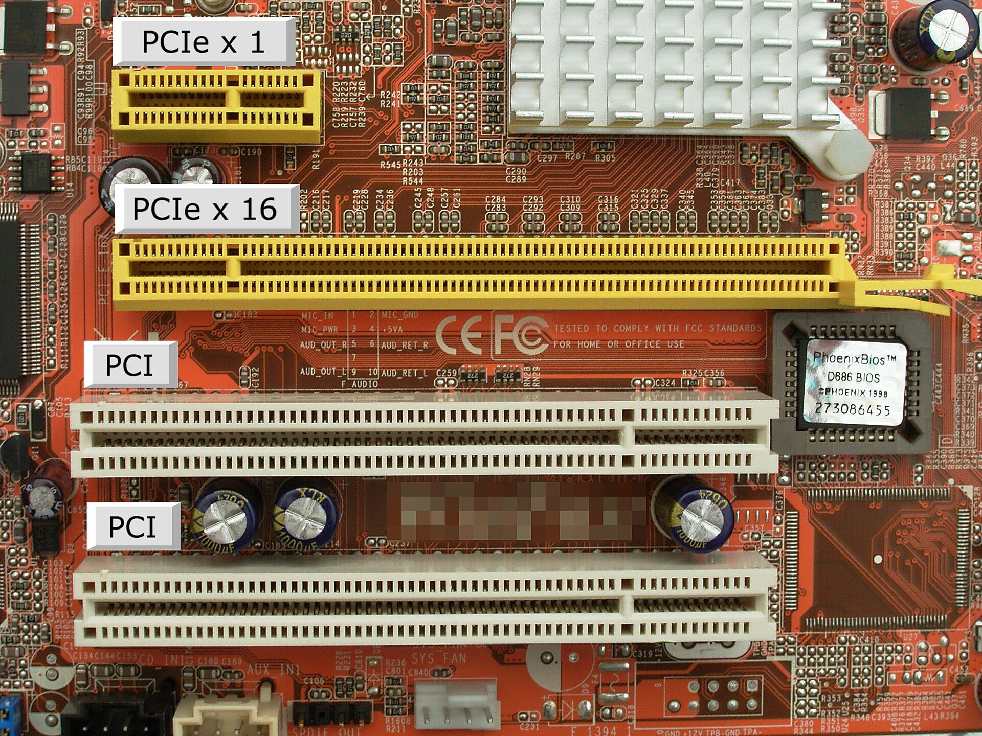 Close-up of a motherboard's expansion slots labelled PCIe x1, PCIe x16 and PCI